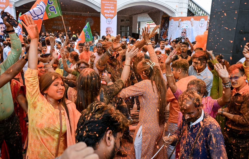 BJP party workers celebrate the party's lead at the BJP Assam State head office